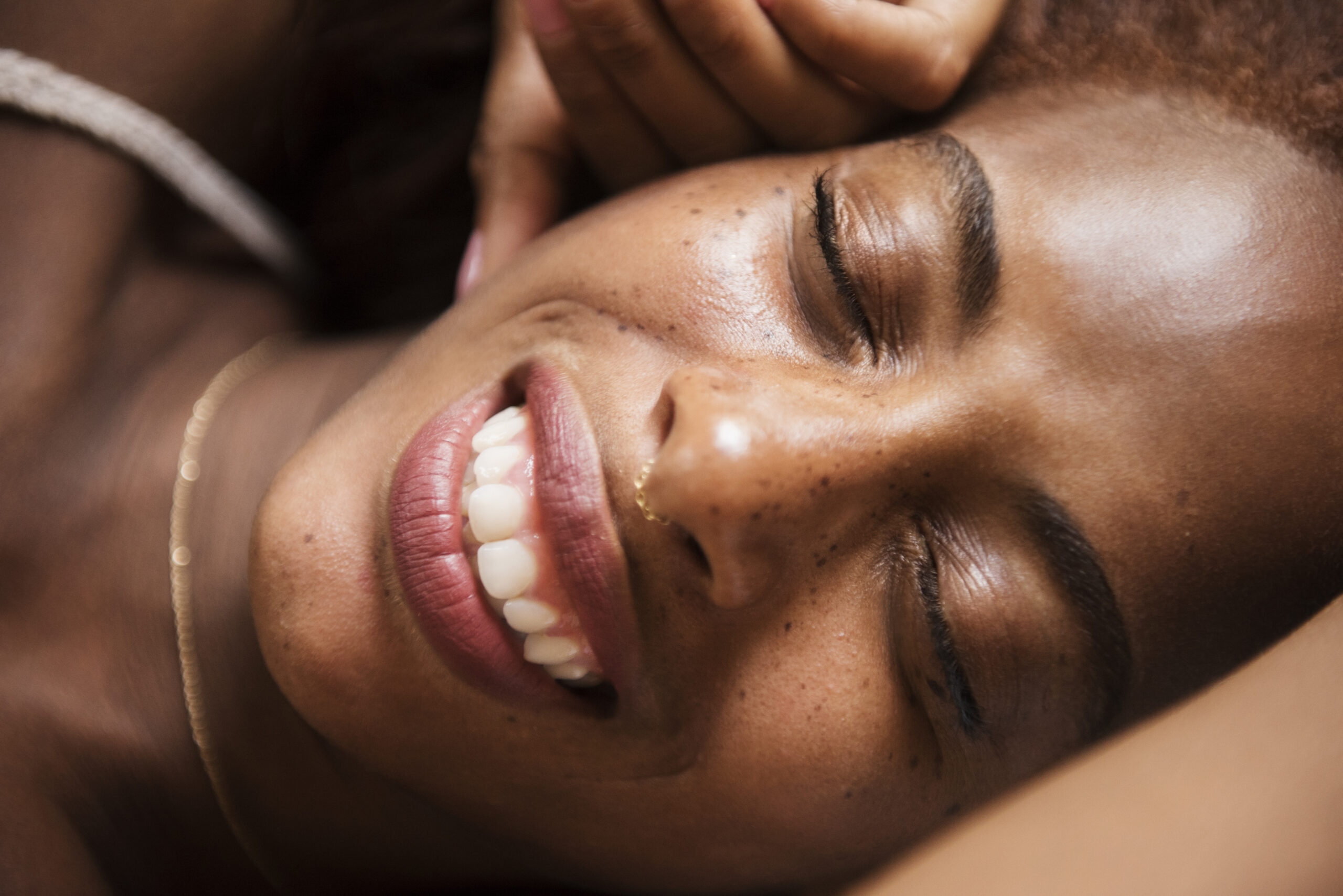 Close up portrait of beautiful woman smiling with her eyes closed